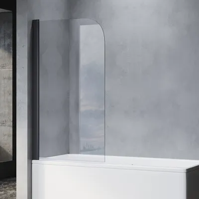 A shower screen attached to a bathtub against a concrete wall.
