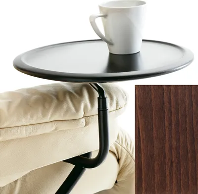 A close-up of a black tray table attached to a beige armchair, with a white mug on the tray. A sample of brown wood grain is shown in the bottom right corner.
