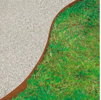 A close-up view of a garden border separating gravel from grass.