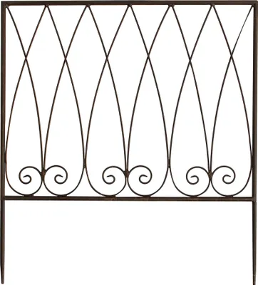 A metal garden fence with decorative scrollwork.
