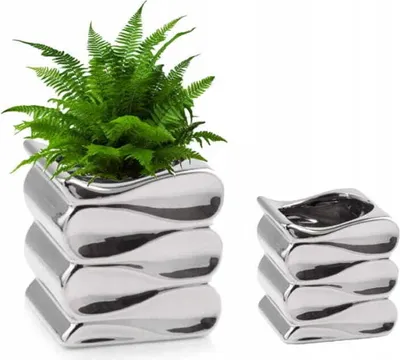 Two silver ceramic planters, one with a fern, against a white background.