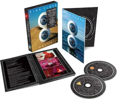 A collection of Pink Floyd P.U.L.S.E. (Restored & Re-Edited) merchandise, including a DVD case, a booklet, and two discs.