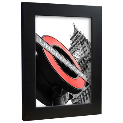 A framed picture of a London Underground sign with Big Ben in the background.