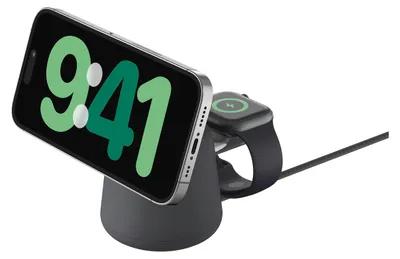 A charging station with a smartphone and a smartwatch docked on it.