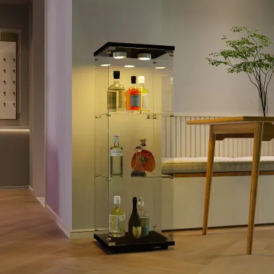 A glass display cabinet with bottles on shelves, placed in a room with a table and chair.