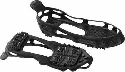 A pair of black overshoes with metal spikes for traction on ice and snow, shown against a white background.