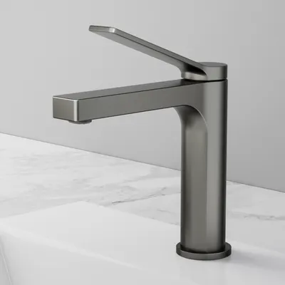 A modern, matte anthracite faucet is shown on a white sink with a marble countertop.