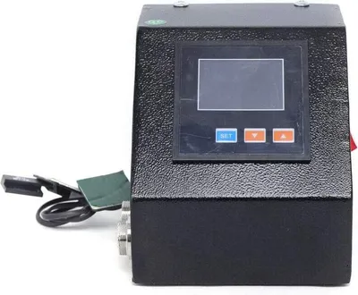 A black electronic device with a screen and buttons, connected to a power cord.