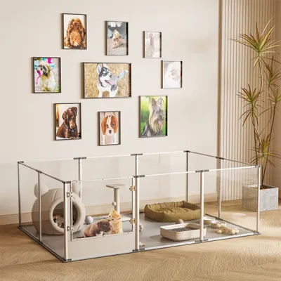 A dog playpen with various pet accessories inside, set against a wall decorated with framed dog portraits.
