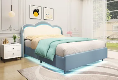 A blue bed with a cloud-shaped headboard and LED lights is shown in a bedroom setting.