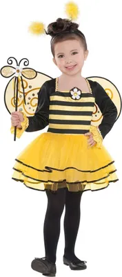 A young girl is posing in a bee costume.