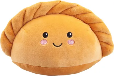 A plush toy shaped like a dumpling or empanada with a smiling face.