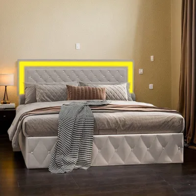 A bed with a tufted headboard and LED lighting in a bedroom setting.