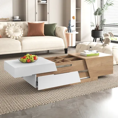 A modern living room scene featuring a white and wood-tone coffee table with storage and drawers, placed on a rug in front of a sofa.