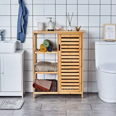 A bathroom scene with a bamboo storage cabinet, sink, and toilet.