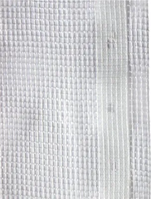 A close-up, full-frame shot of a white fabric tarp with a grid pattern and reinforced vertical stripes.