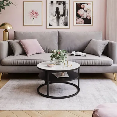 A living room scene with a sofa, coffee table, and artwork.