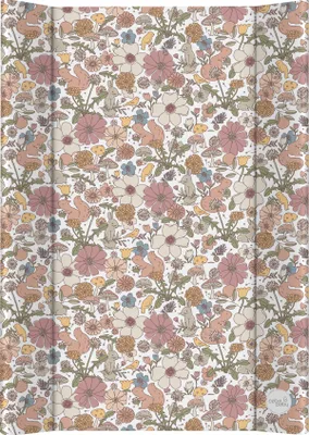 A flat lay of a baby changing mat with a floral and woodland creature pattern.