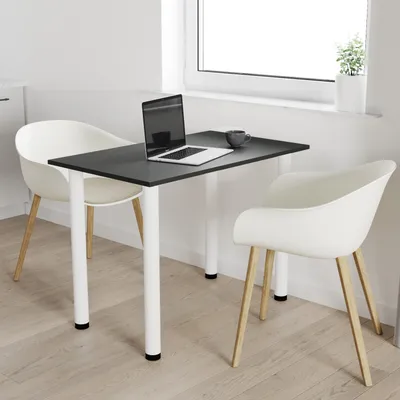 A small black table with white legs and two white chairs in a room with a window.