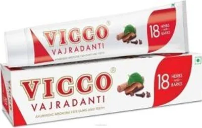 A tube and box of Vicco Vajradanti toothpaste are shown stacked on top of each other.