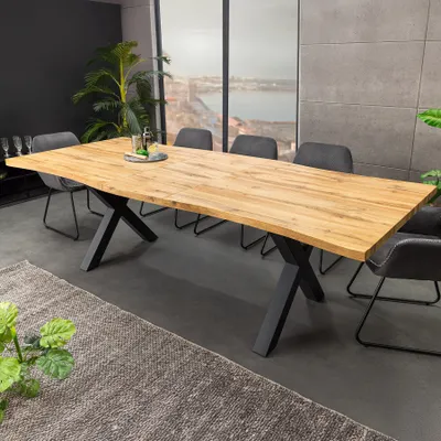 A dining room setting with a large wooden table and chairs.