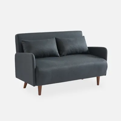 A dark gray two-seater sofa with two throw pillows, shown from a three-quarter front view on a light gray background.
