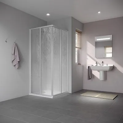 A modern bathroom with a corner shower enclosure, sink, and mirror.