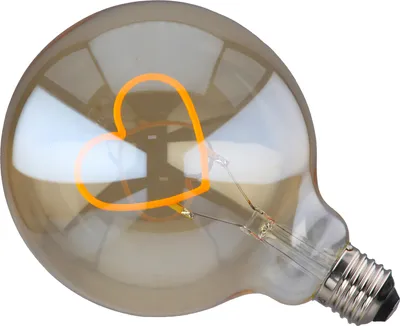 A close-up studio shot of a decorative light bulb with a heart-shaped filament.