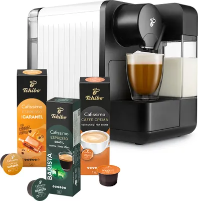 A Tchibo Cafissimo coffee machine with several boxes of coffee capsules.