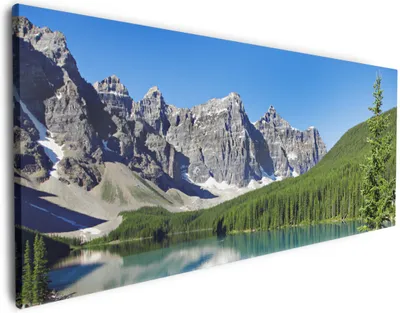 Produktbild von Wallario Premium Leinwandbild Tiefblauer See mit Bergpanorama und Wäldern  Kanada in Größe 80 x 200 cm