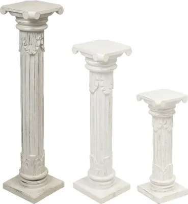 Three white decorative pedestals of varying heights against a white background.