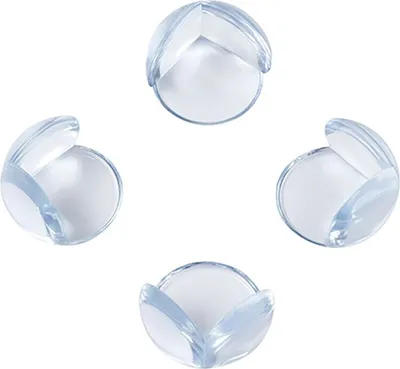 Four clear corner protectors arranged in a diamond shape on a white background.