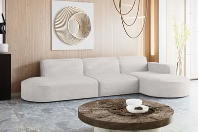 A modern living room with a sectional sofa and a rustic coffee table.