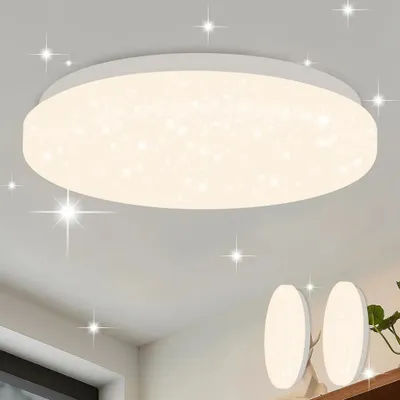 A modern, round LED ceiling light with a starry sky effect, shown mounted on a white ceiling. Two smaller, similar lights are visible in the background.
