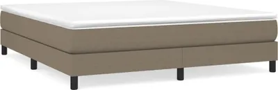 A taupe boxspring bed frame with a white mattress on top, shown from a side-angle on a white background.