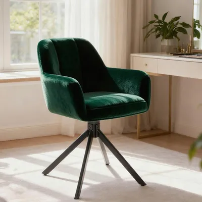 A green velvet chair is placed in a room with a desk and window.