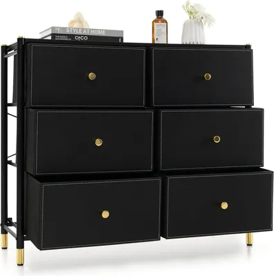 A black fabric dresser with six drawers and gold handles is shown against a white background.