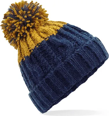 A close-up studio shot of a knitted beanie with a pom-pom.