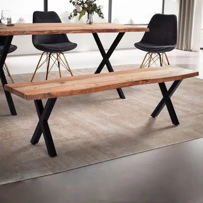 A wooden bench and dining table with chairs in a modern dining room setting.