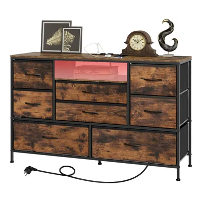 A dresser with multiple drawers and LED lighting, decorated with framed pictures, a clock, and a sculpture.