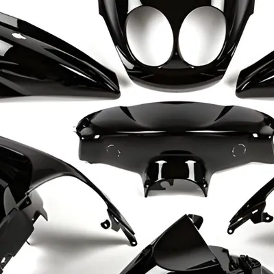 A collection of black motorcycle fairing parts arranged against a white background.