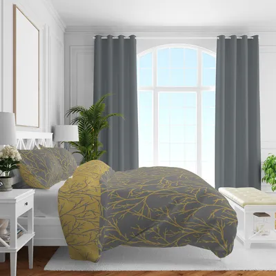 A bedroom scene with a bed dressed in bedding with a branch pattern.