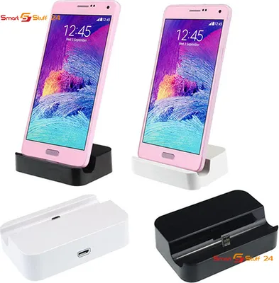 Two pink smartphones are docked in black and white charging stands, with the charging stands also shown separately below.