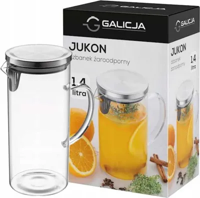 A product shot of a glass jug and its packaging, with oranges and spices as decoration.