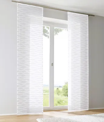 Two white sheer curtains with a wave pattern hang in front of a window, with a view of a green landscape outside.