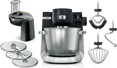 A kitchen machine with various attachments is displayed against a white background.