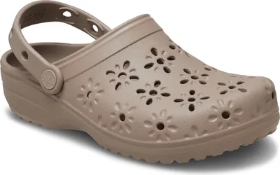 A single beige Croc clog with a floral cut-out design is shown from a side-diagonal angle on a white background.