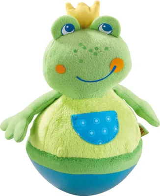 A plush toy frog wearing a crown and a shirt with a pocket.