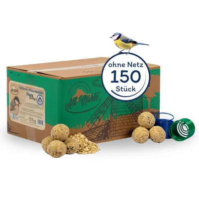 A cardboard box of bird food with bird food balls and seeds in front of it, and a bird perched on top.