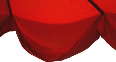 A close-up view of the bottom edge of a red umbrella canopy.